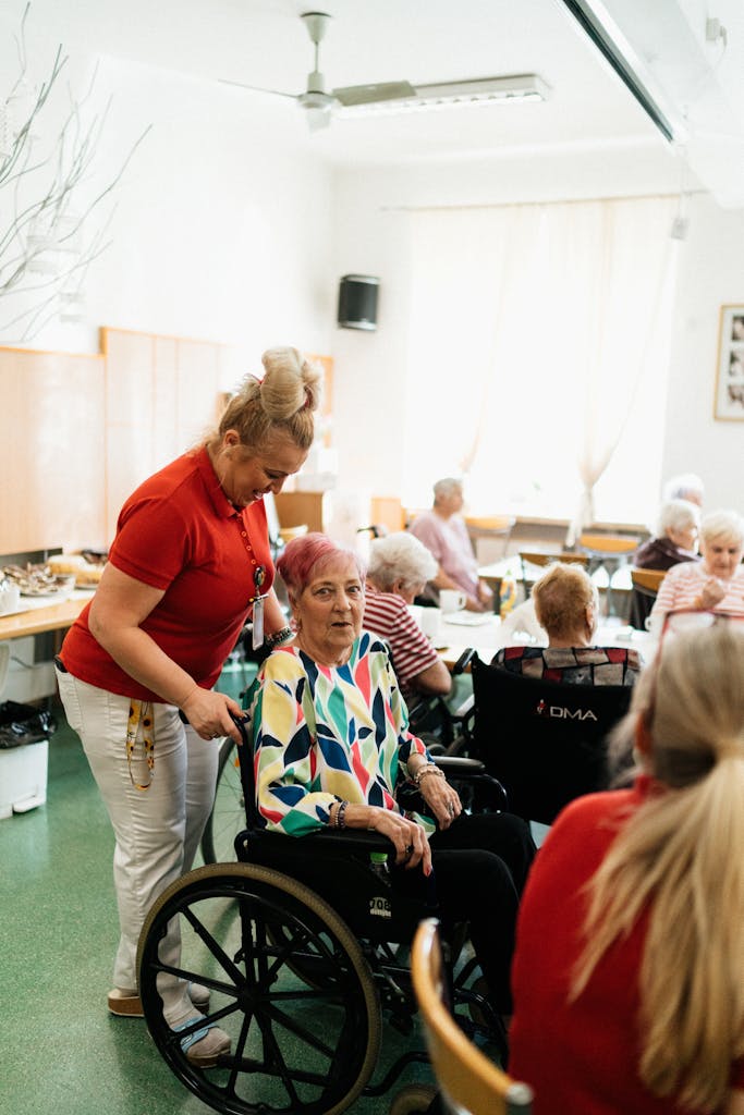 A Woman assisting an Elderly Woman in a Wheelchair