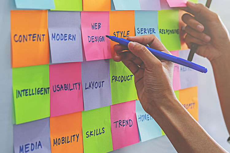 Team writing digital marketing terminology on post its Team writing digital marketing terminology on post its