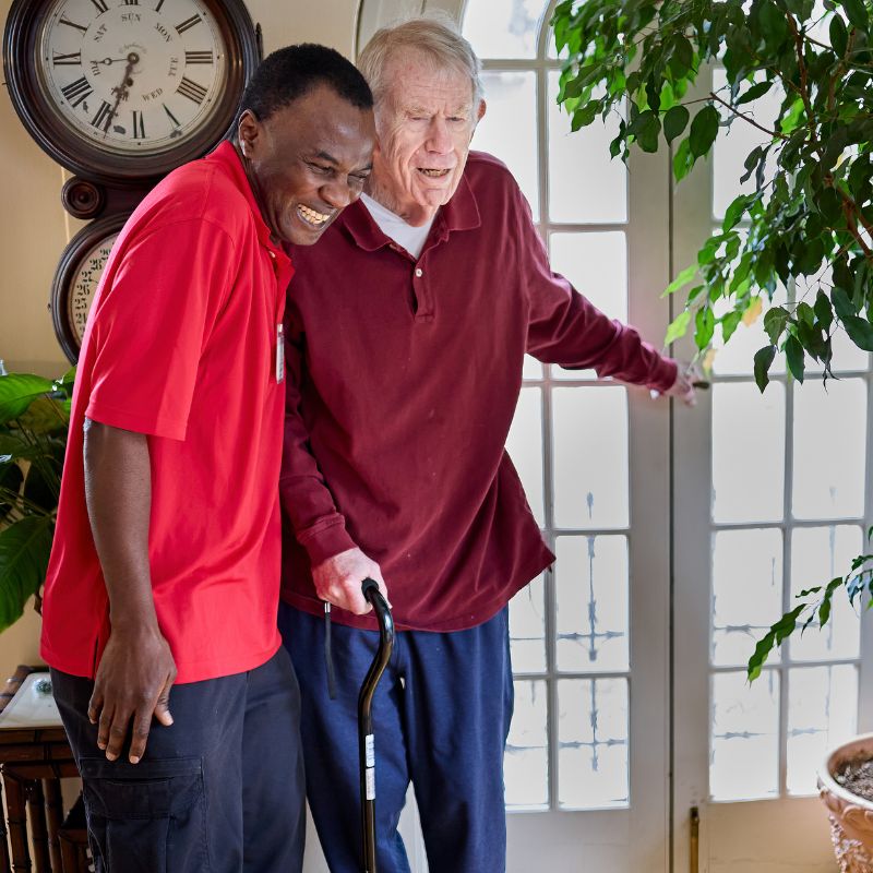 caregiver helping client walk square