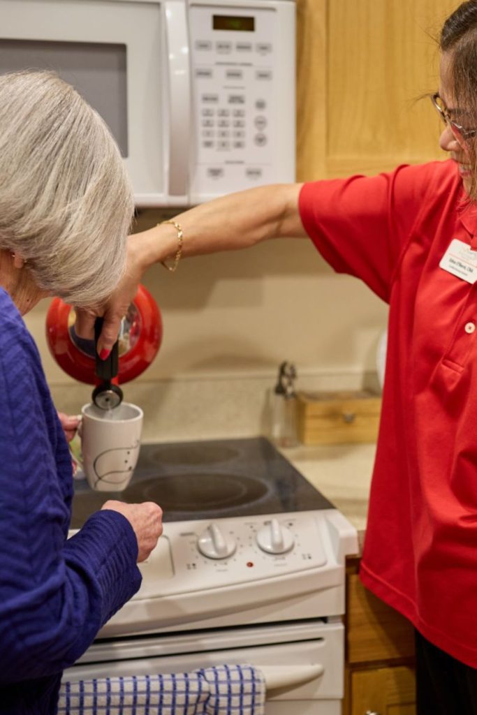 client and caregiver pouring water
