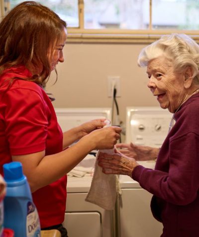 caregiver helping client with laundry square