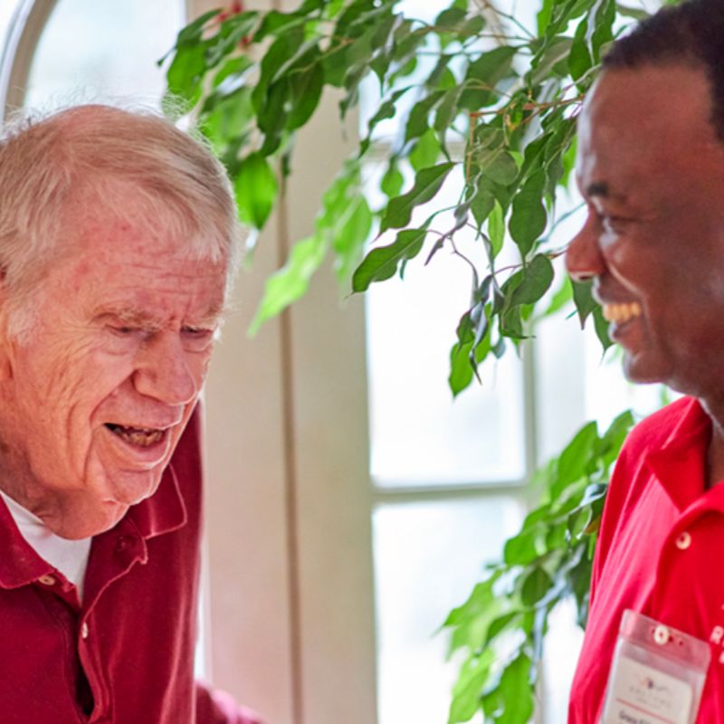 rhythms home care caregiver laughing with senior male client (2)