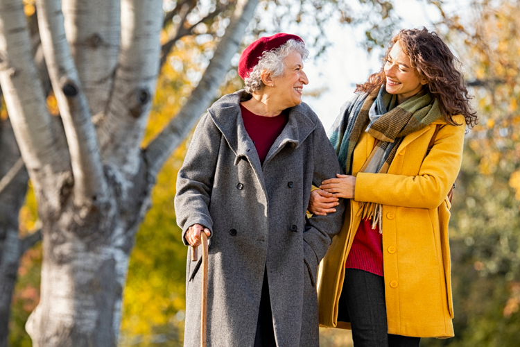 rhythms home care female caregiver walking with senior woman client in the autumn