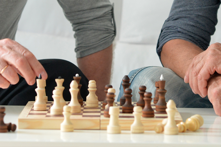 rhythms home care male hands playing chess
